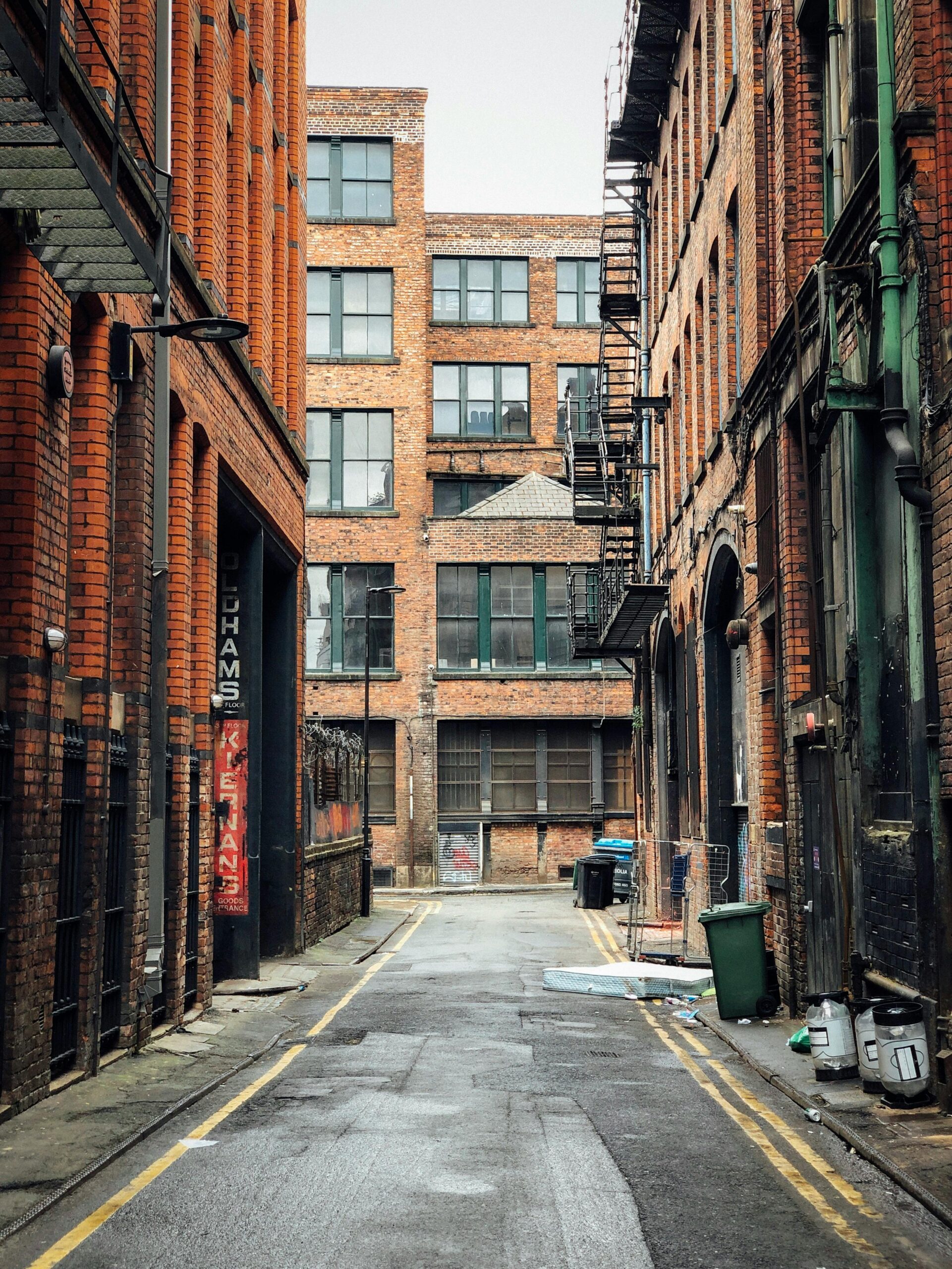 Explore the vintage charm of a brick-lined alleyway in Manchester, England, showcasing urban architecture.