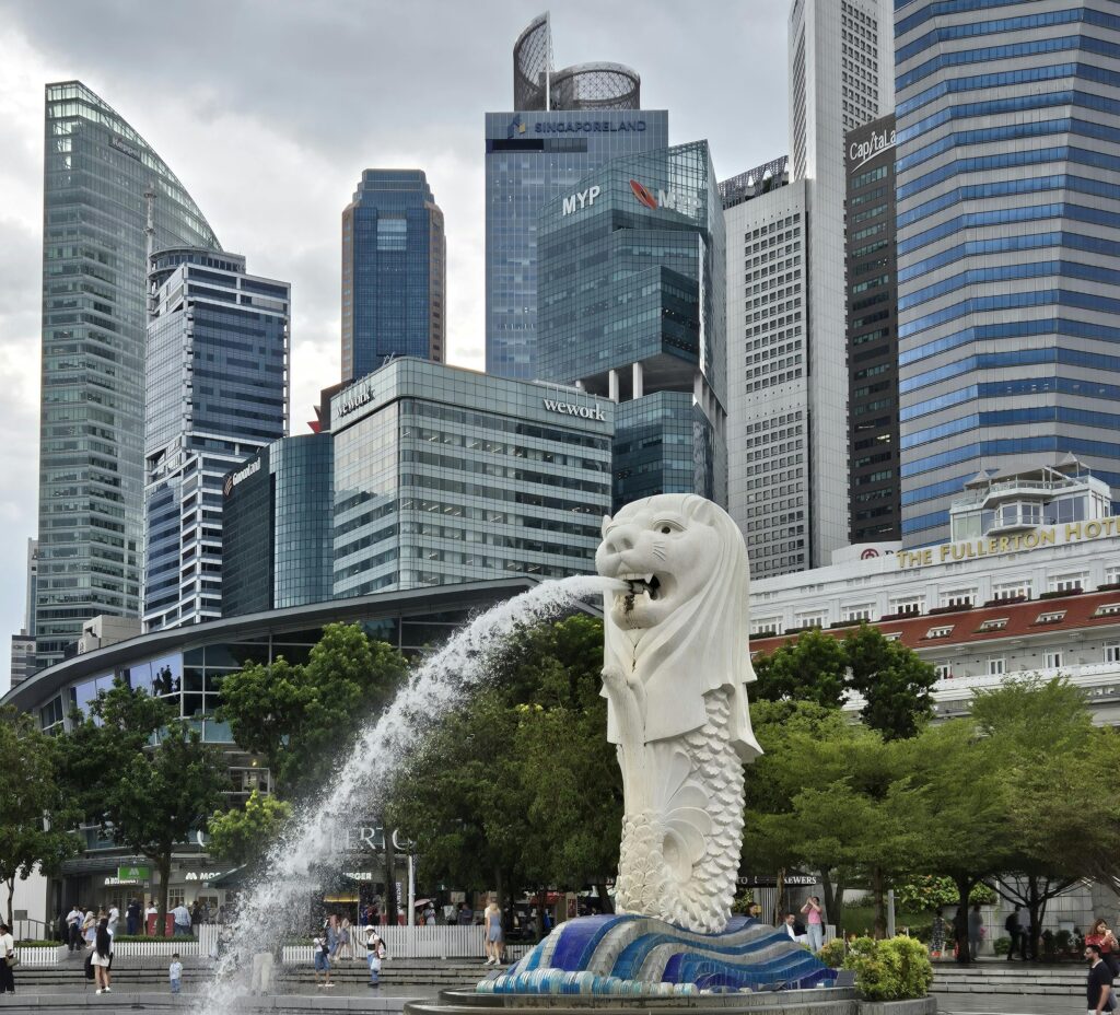 The Merlion fountain with Singapore's modern skyline in the background.